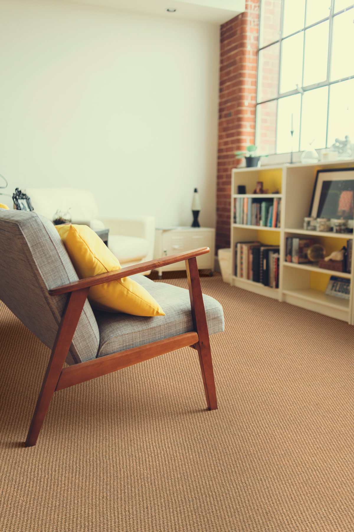 dragon-grass-edgewood-sisal-living-space-1200 Accra Linen sisal rug beneath a pale wood bed with striped bedding.