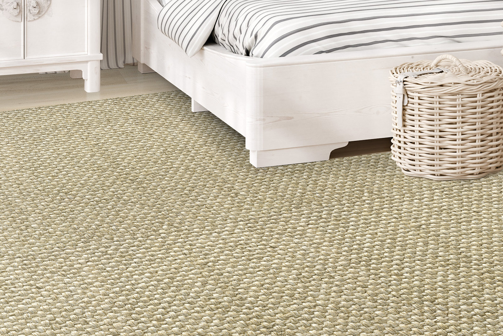 Accra Linen sisal rug beneath a pale wood bed with striped bedding.